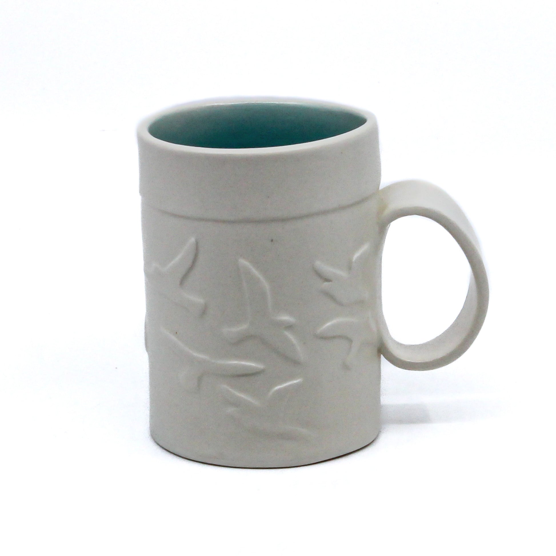 White mug with birds and turquoise inside
