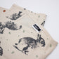 Tea towel with bunnies and small flowers and leaves