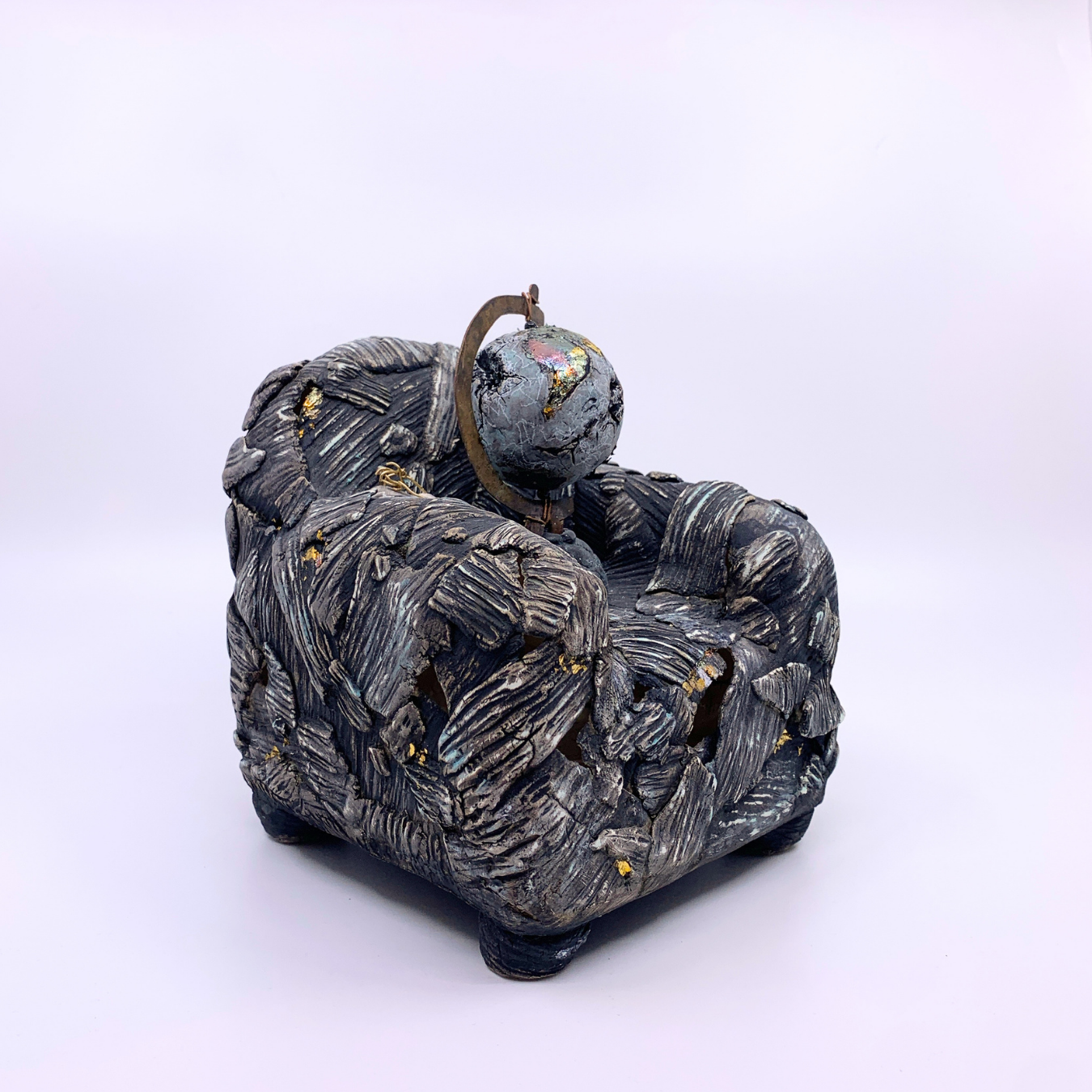 sculpture of couch with earth and dead bird 