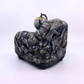 sculpture of couch with earth and dead bird 