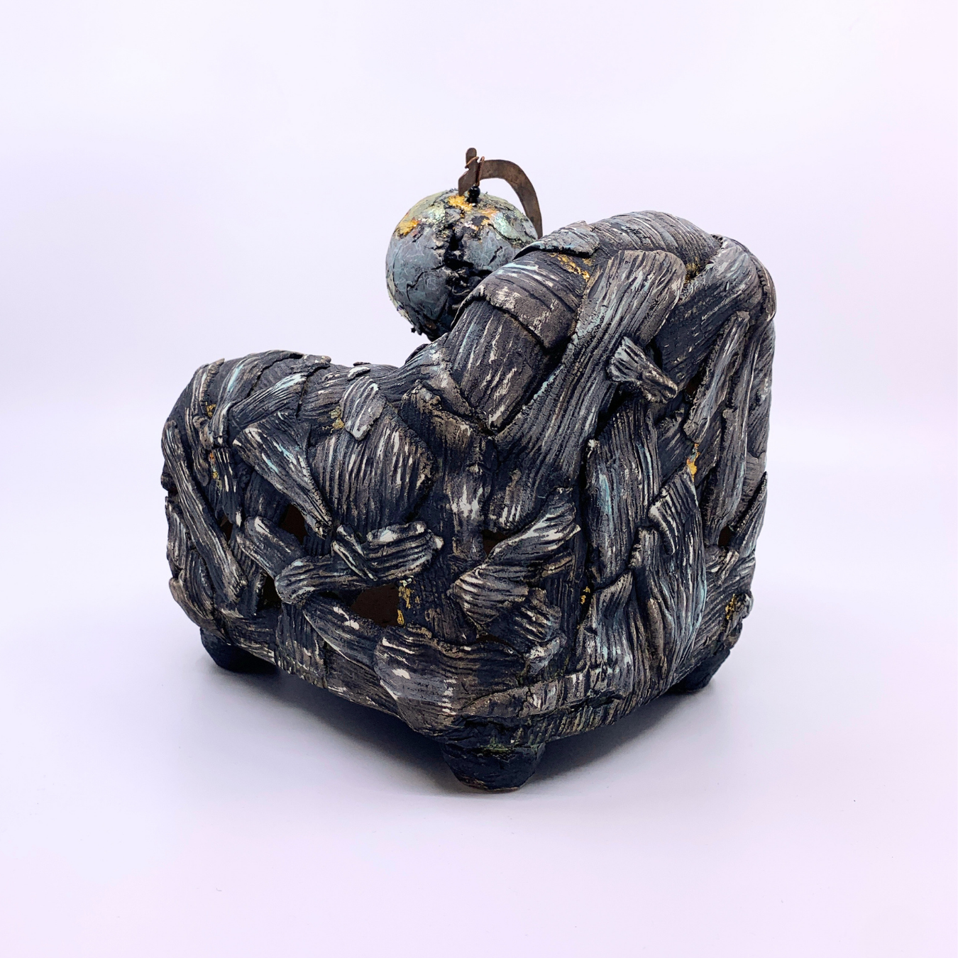 sculpture of couch with earth and dead bird 