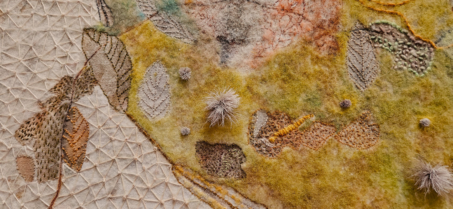 Textile art piece with natural patterns and textures