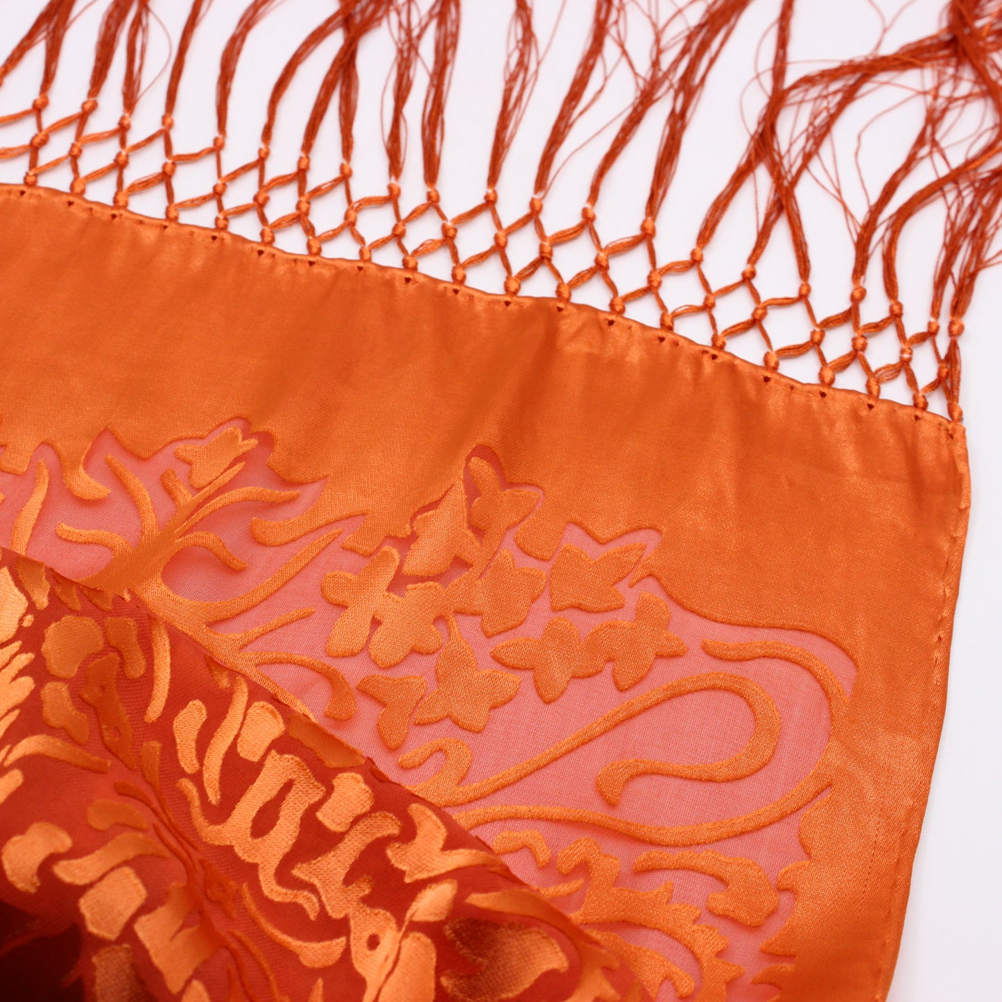 detail of Orange scarf with long tassels 