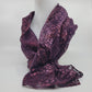 Purple patterned scarf on a mannequin against a white background