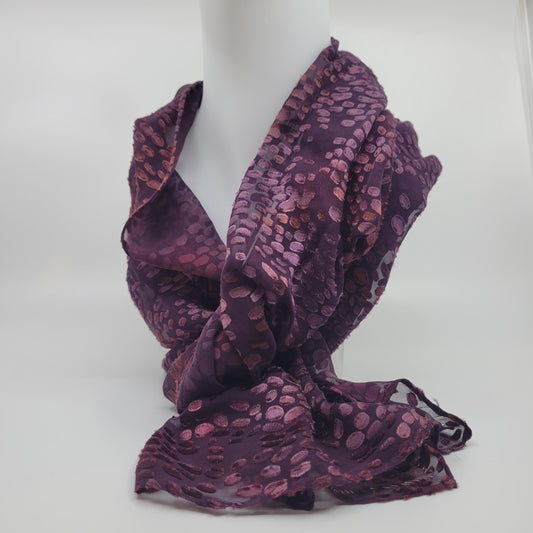 Purple patterned scarf on a mannequin against a white background
