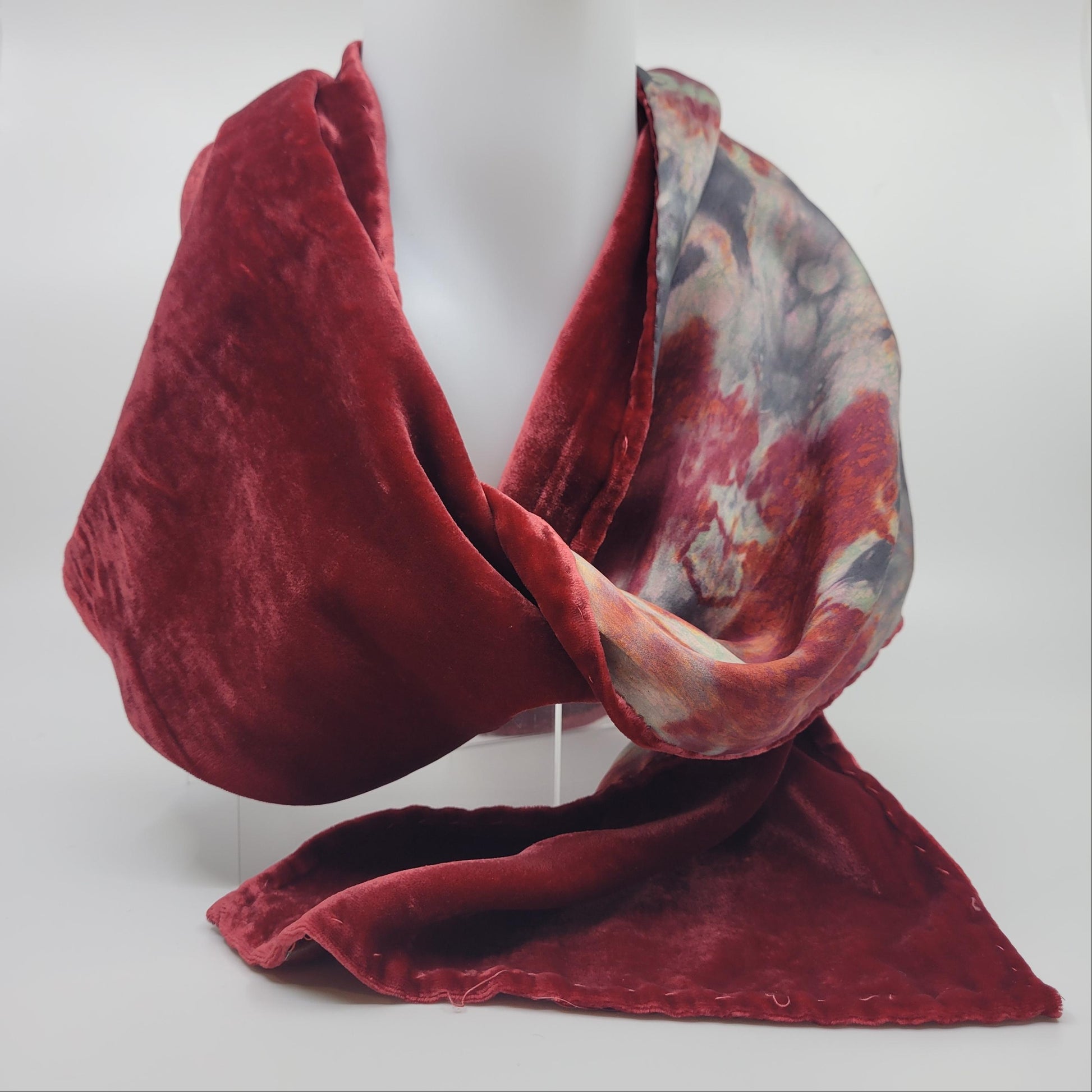 Red velvet scarf with an abstract pattern on a white background