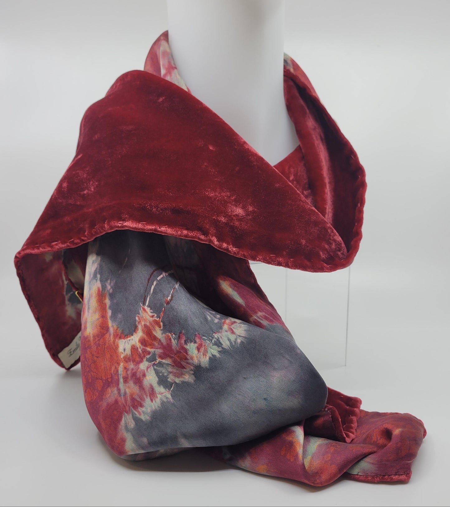 Red velvet scarf with an abstract pattern on a white background