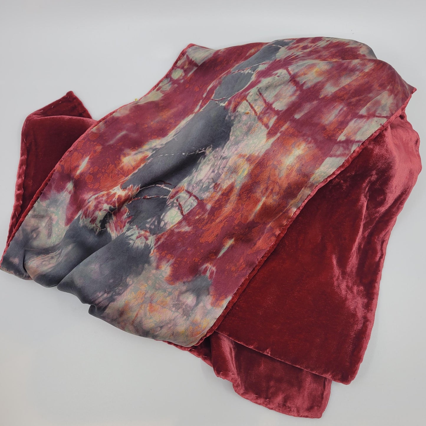 Red velvet scarf with an abstract pattern on a white background