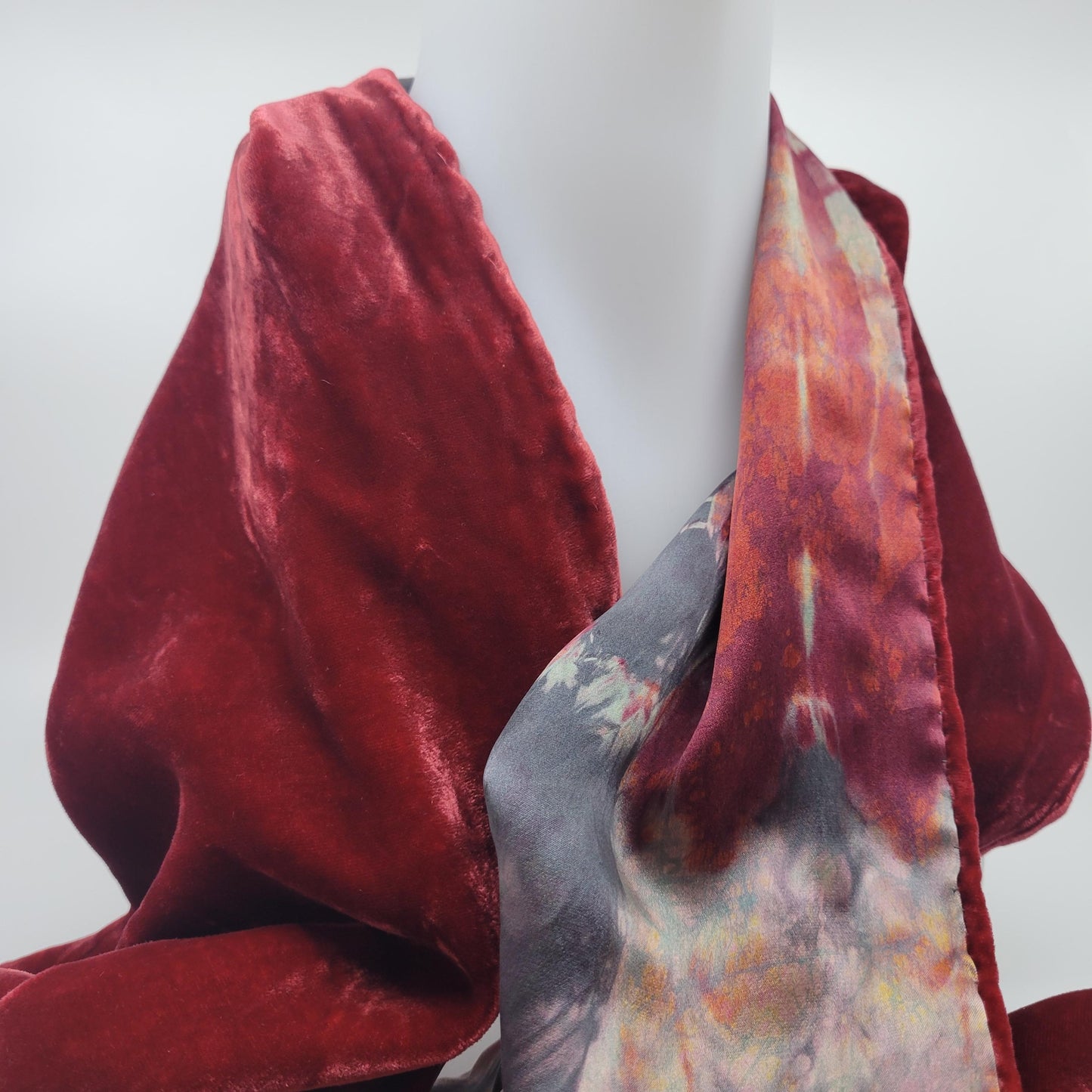Red velvet scarf with an abstract pattern on a white background