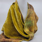 Lime green/yellow velvet scarf on a white background