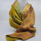 Lime green/yellow velvet scarf on a white background