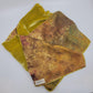 Lime green/yellow/brown velvet scarf on a white background