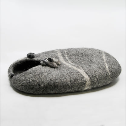 Grey cat house with rocks