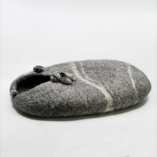 Grey cat house with rocks