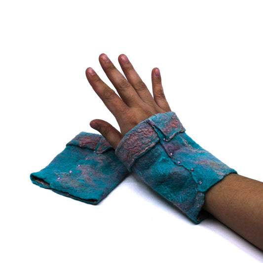 A hand wearing turquoise and pink wrist warmers