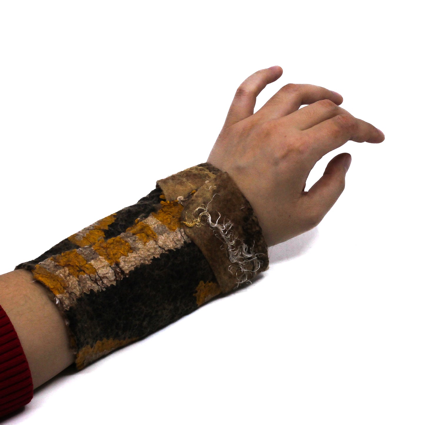 An arm wearing brown wrist warmer