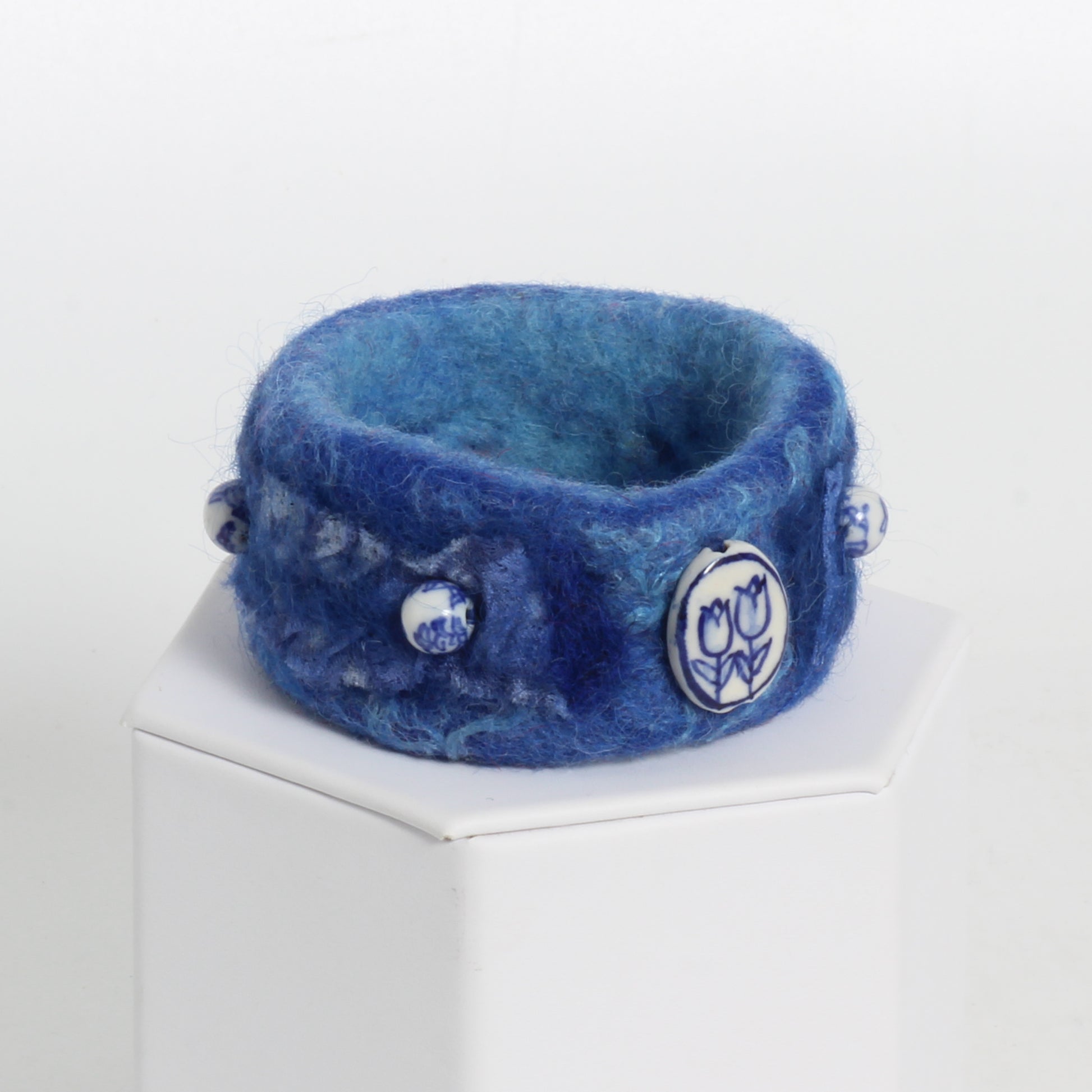 Blue felted bracelet with white and blue beads 