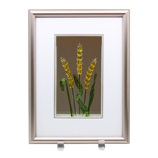 Three gold wheat and three green leaves in pewter coloured frame on mirrored background 