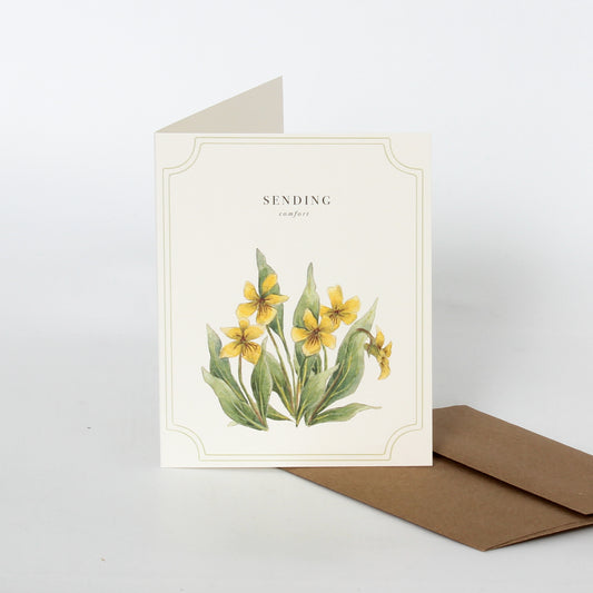 Off-white card with vintage floral design with words Sending Comfort" on it, with a brown envelope.