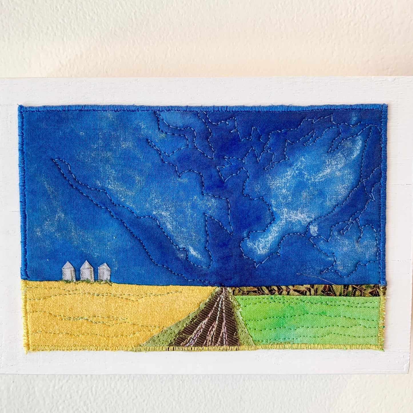 Blue, yellow, and green fiber art of Saskatchewan landscape