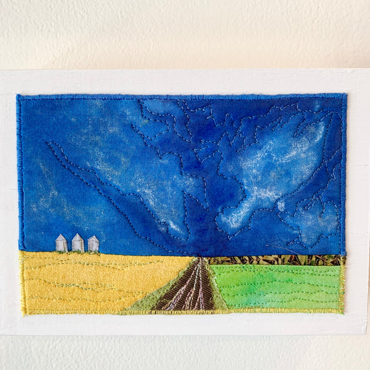 Blue, yellow, and green fiber art of Saskatchewan landscape