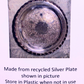 A round tarnished silver plate with a scalloped rim, shown on a light background with text below stating it is made from recycled silver plate.