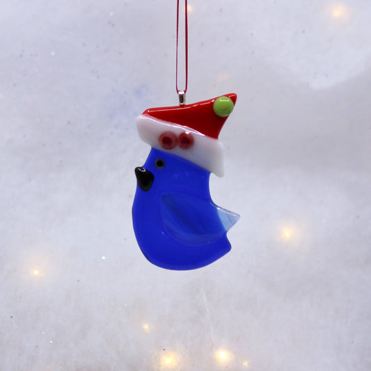 Glass blue bird with Santa hat with green dot. Ornament 