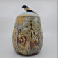 Ceramic jar with deer design on a white background
