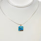 Necklace with a square pendant featuring a nature scene on a white background