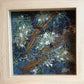 Framed artwork of embroidered flowers and wood 