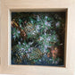 Framed embroidery of flowers with a wooden frame