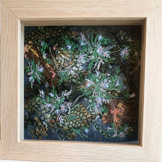 Framed embroidery of flowers with a wooden frame