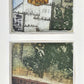 Decorative window framing a painting of a grain elevator building and landscape.