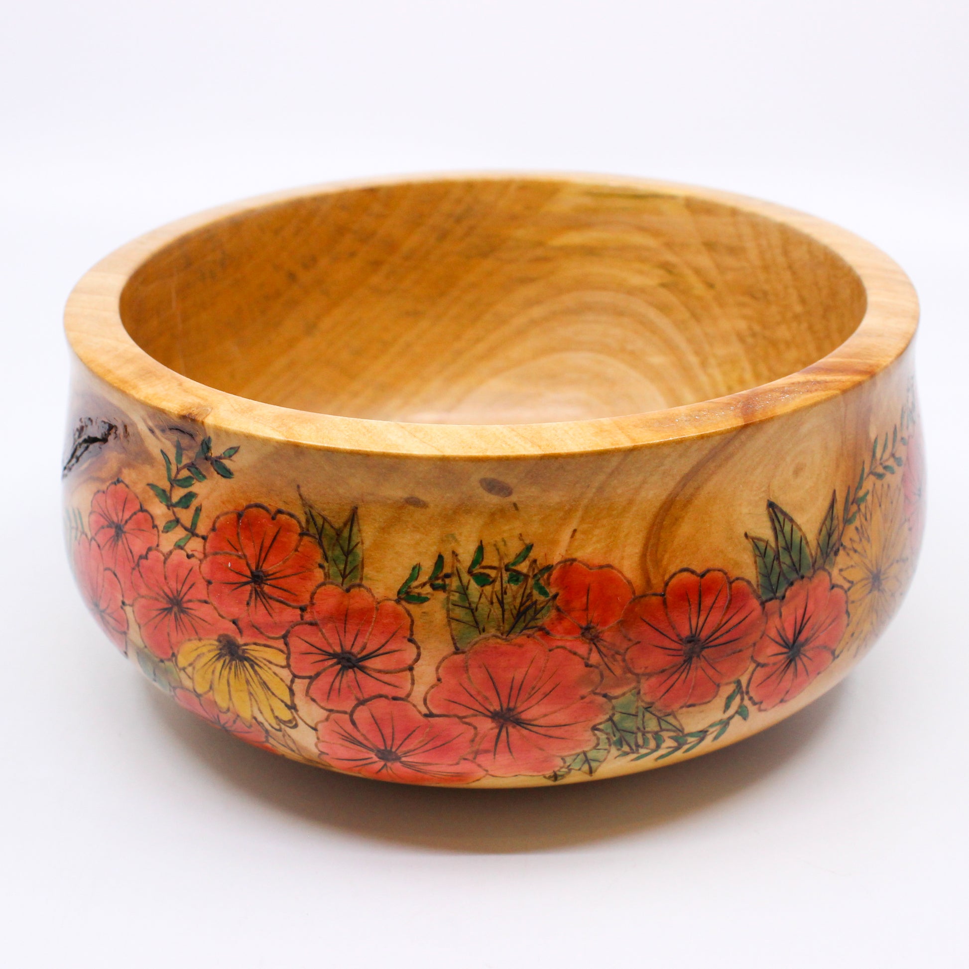 Wooden bowl with pattern of red flowers with green foliage and yellow flowers 