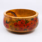 Wooden bowl with pattern of red flowers with green foliage and yellow flowers 