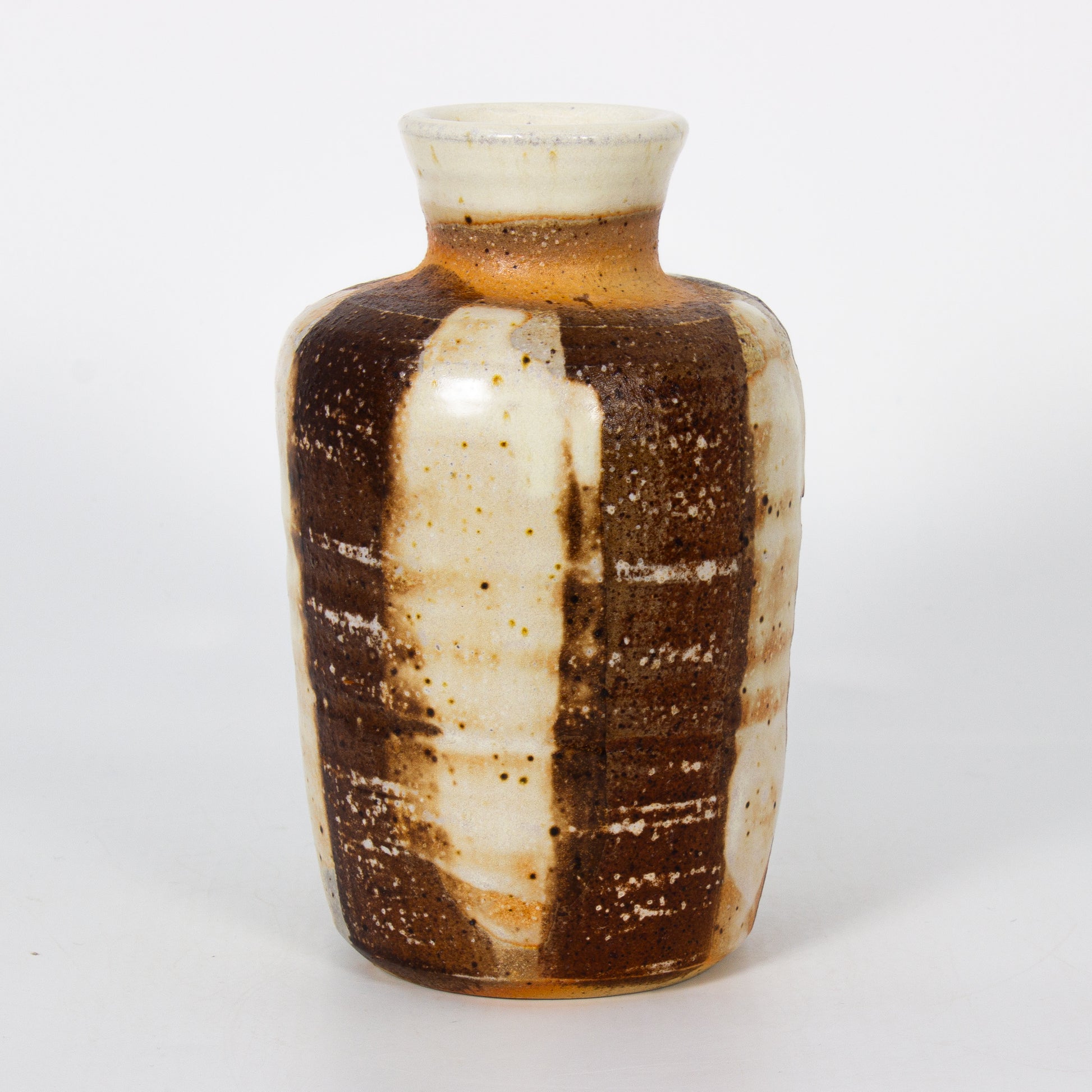 Ceramic vase with brown and white striped pattern on a white background