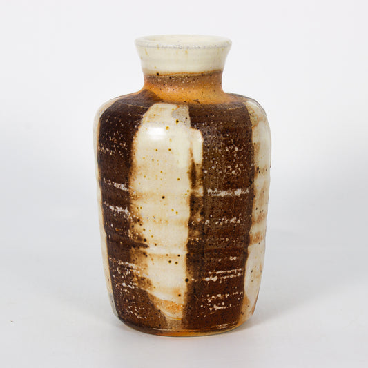 Ceramic vase with brown and white striped pattern on a white background