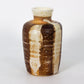 Ceramic vase with brown and beige glaze on a white background