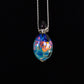 Colorful glass pendant necklace on a black background