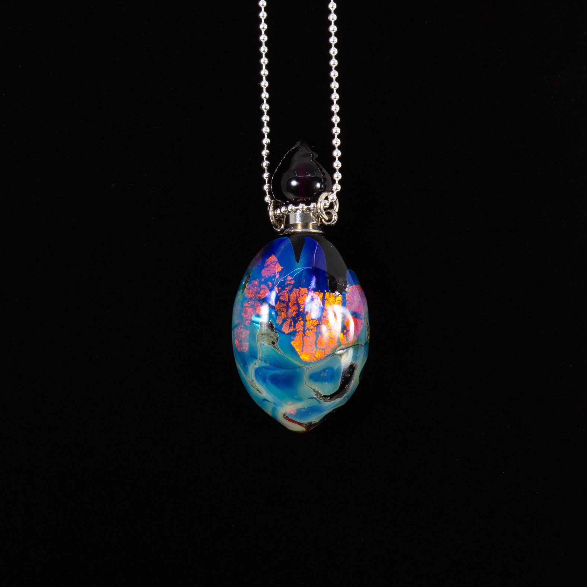 Colorful glass pendant necklace on a black background