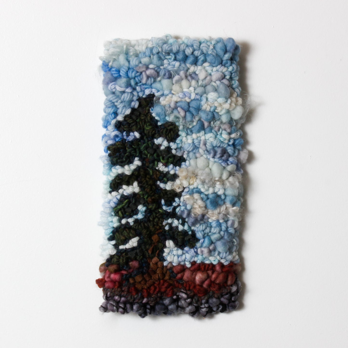 Textile art piece of spruce tree