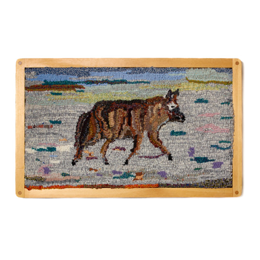 Hand hooked wool rug of coyote in wooden frame