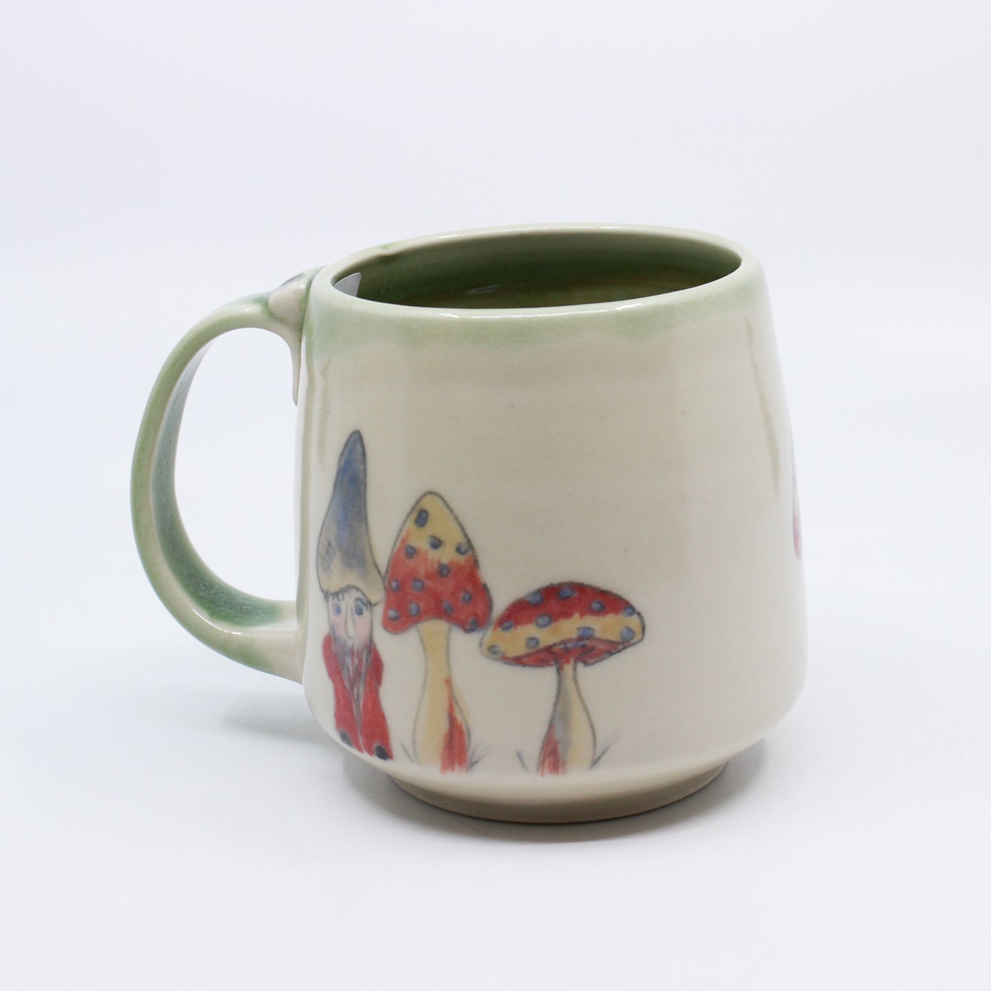 Hand-painted mushrooms on white and green mug with hiding gnome
