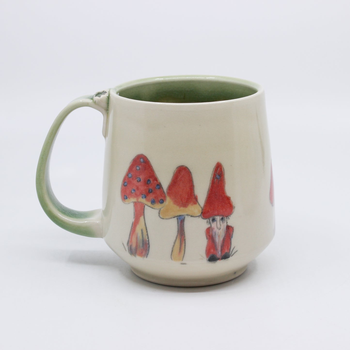 Hand-painted mushrooms with hiding gnome on white and green mug 