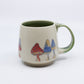 Mug with Red and blue mushrooms and green handle