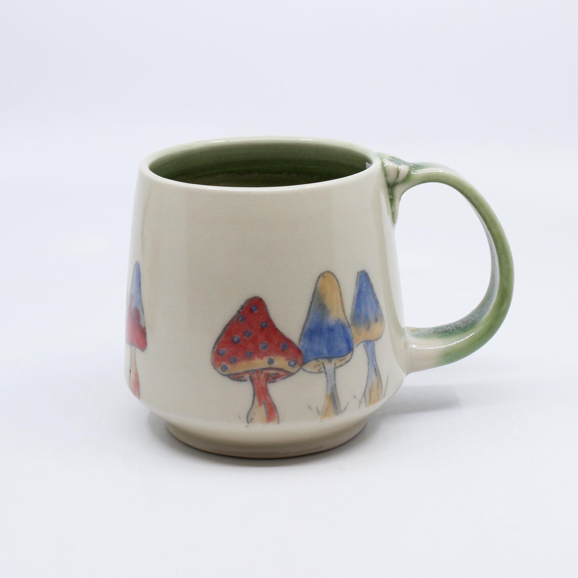 Mug with Red and blue mushrooms and green handle