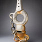 Clay sculpture with chain on a gray background