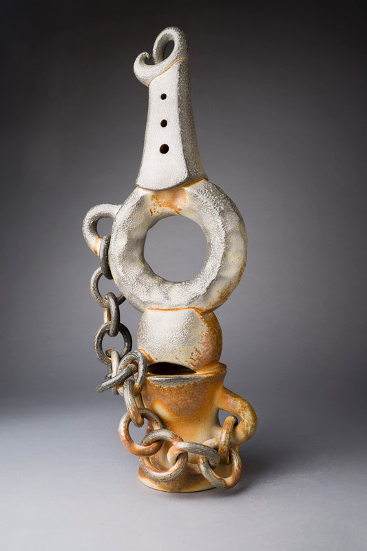 Clay sculpture with chain on a gray background