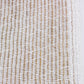 close up detail of white and beige scarf 