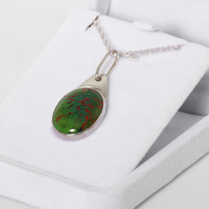 Green and red pendant on silver chain 